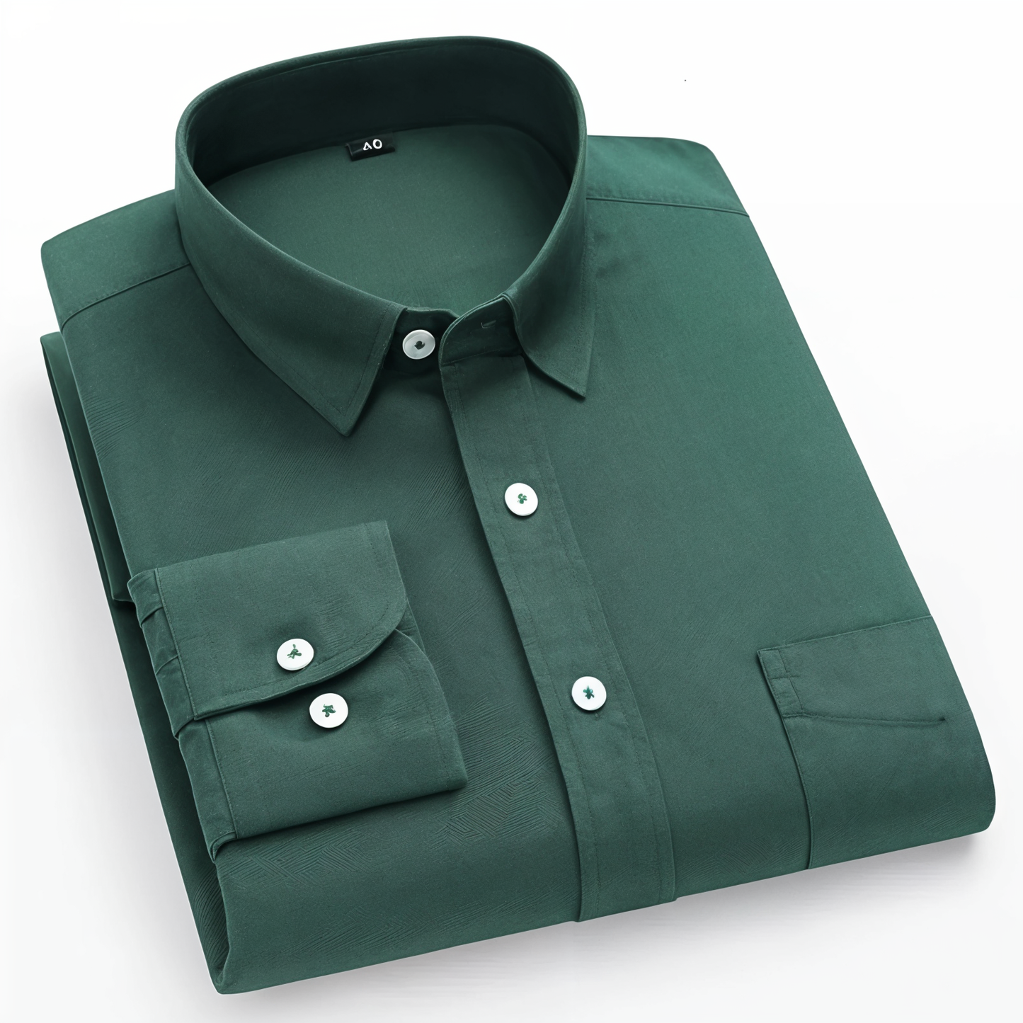 A folded green cotton shirt with long sleeves and a collar, displayed against a white background.