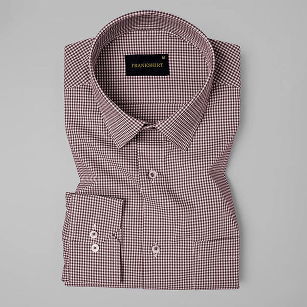 Folded checkered shirt with brand label on a gray background