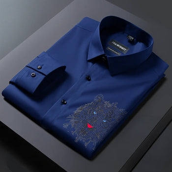 Folded blue shirt with a tiger emblem on a dark surface