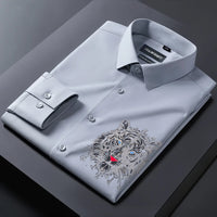 Gray dress shirt with a tiger embroidery design on a dark surface