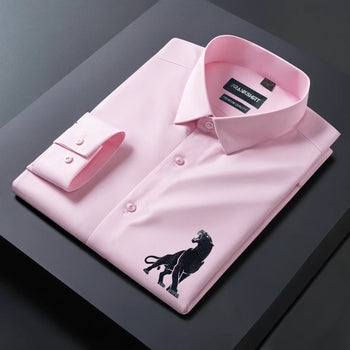 Pink dress shirt with a black embroidered lion design on a dark surface