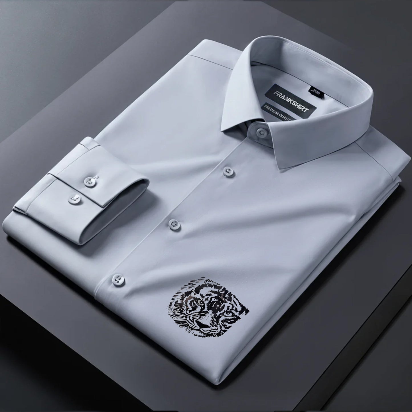 Gray dress shirt with a tiger emblem on a dark surface