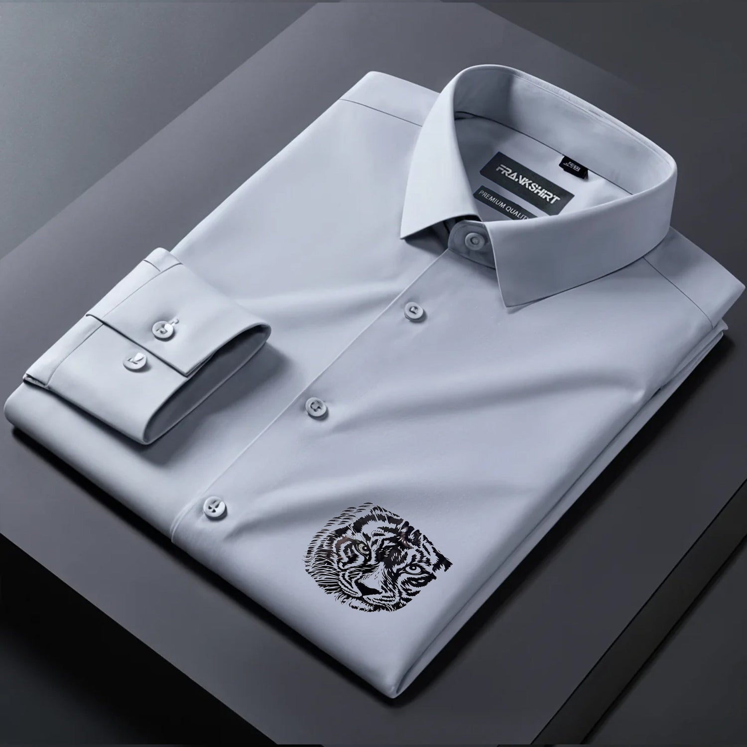 Gray dress shirt with a tiger emblem on a dark surface