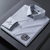 Gray dress shirt with a tiger emblem on a dark surface
