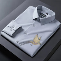 Light gray dress shirt with gold eagle embroidery on a dark surface