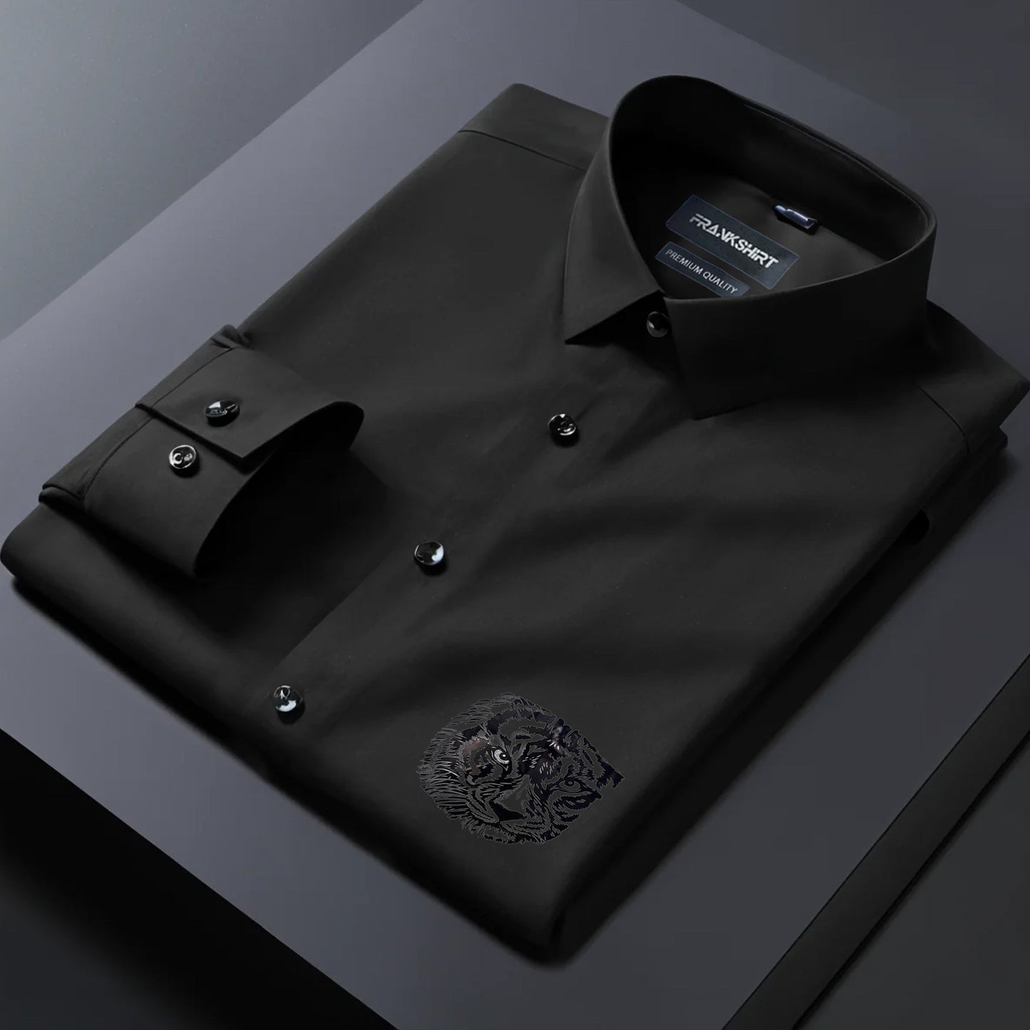 Folded black dress shirt with a brand label on a dark background