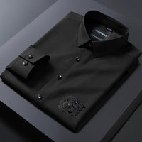 Folded black dress shirt with a brand label on a dark background