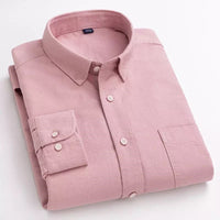 Folded pink cotton shirt on a plain background, displaying the front view with buttons and a collar.