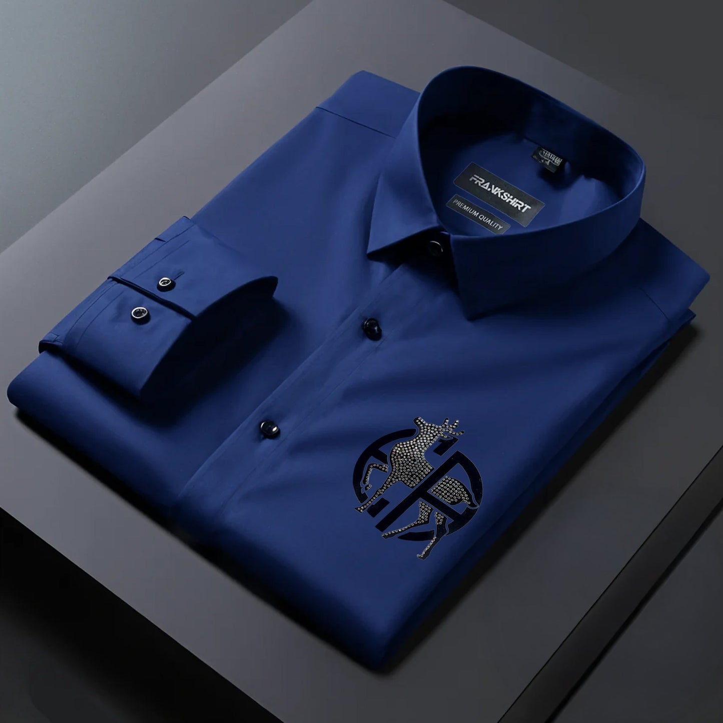 Folded blue shirt with a brand label on a dark surface