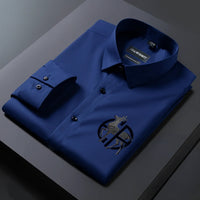 Folded blue shirt with a brand label on a dark surface