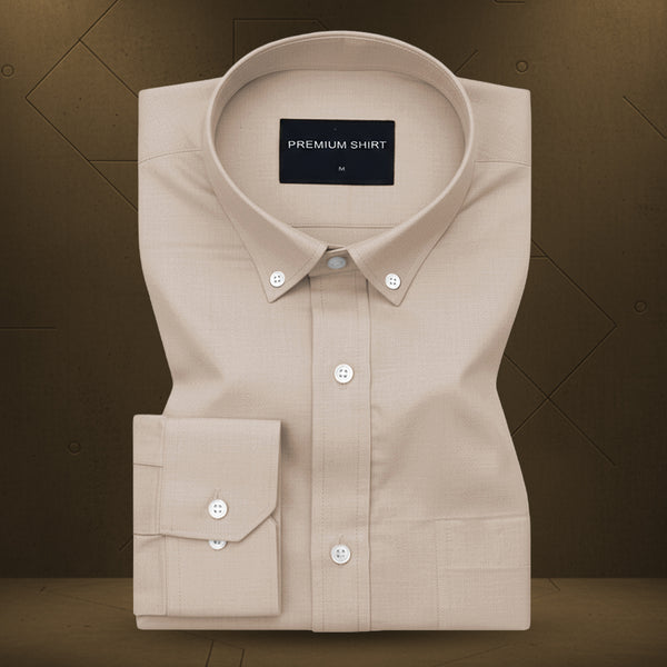 Beige dress shirt with a visible brand label on a brown background