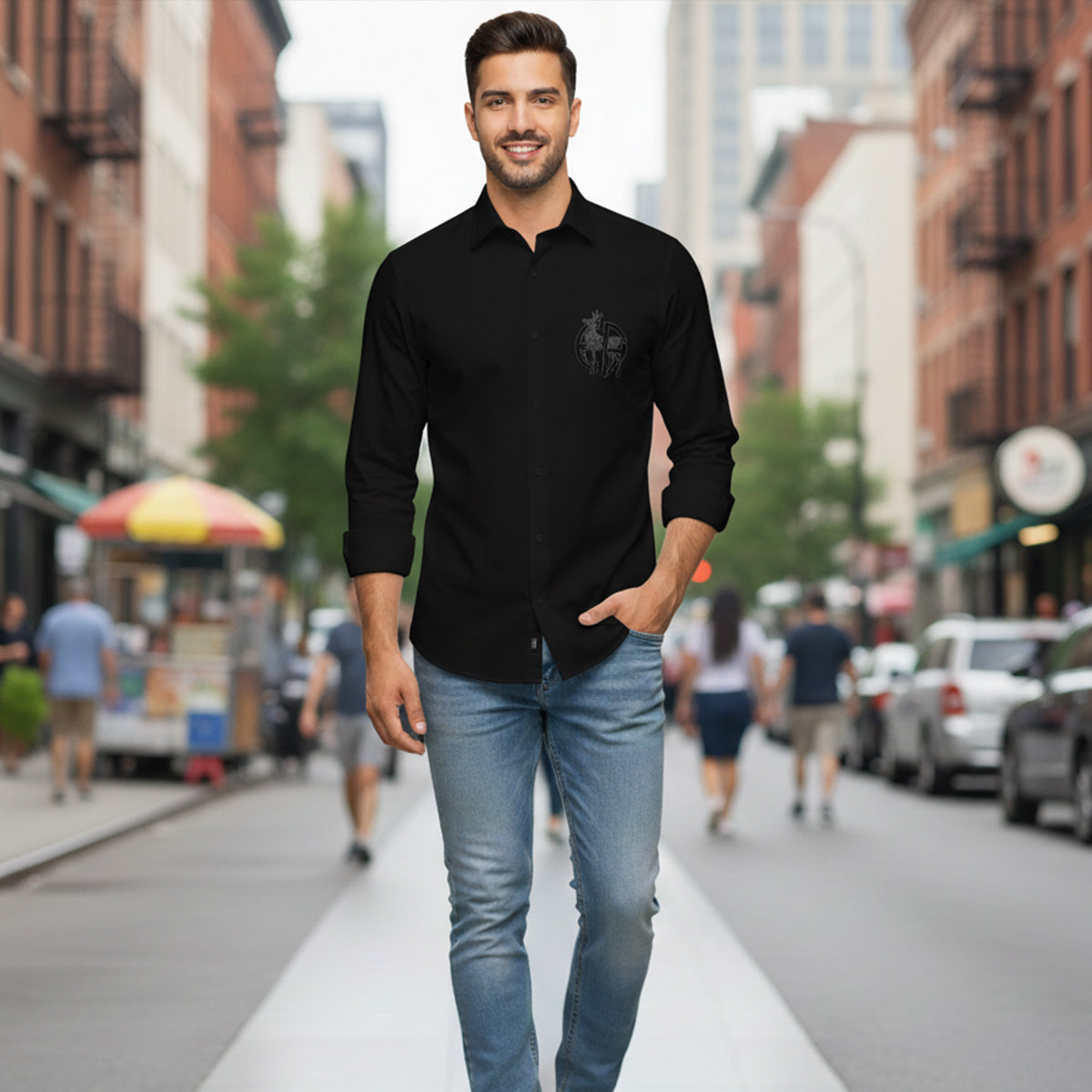 Man wearing a black shirt with a logo on a city street