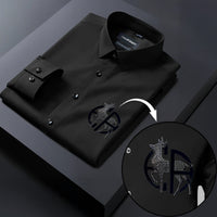 Black dress shirt with a detailed logo on a dark background
