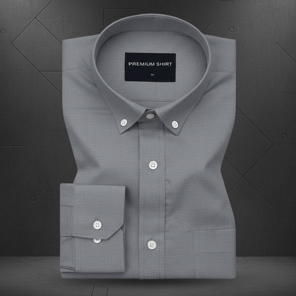 Folded gray shirt with a visible brand label on a dark background