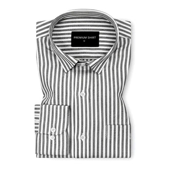 Folded black and white striped shirt with a visible brand label on a white background