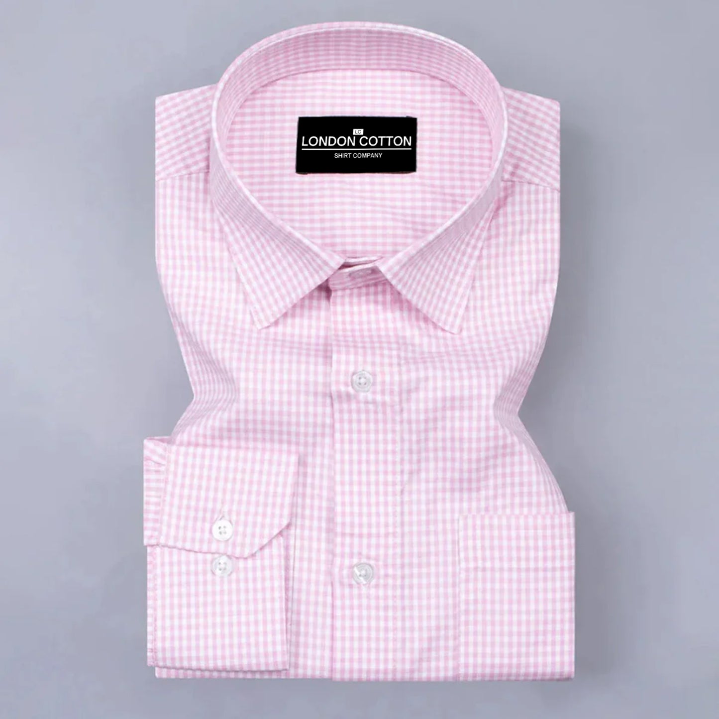 Pink checkered dress shirt with 'London Cotton' label on a gray background