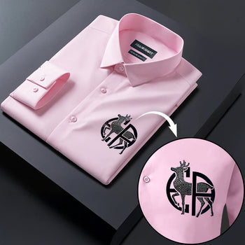 Pink dress shirt with a brand logo on a dark surface, showing a close-up of the logo.