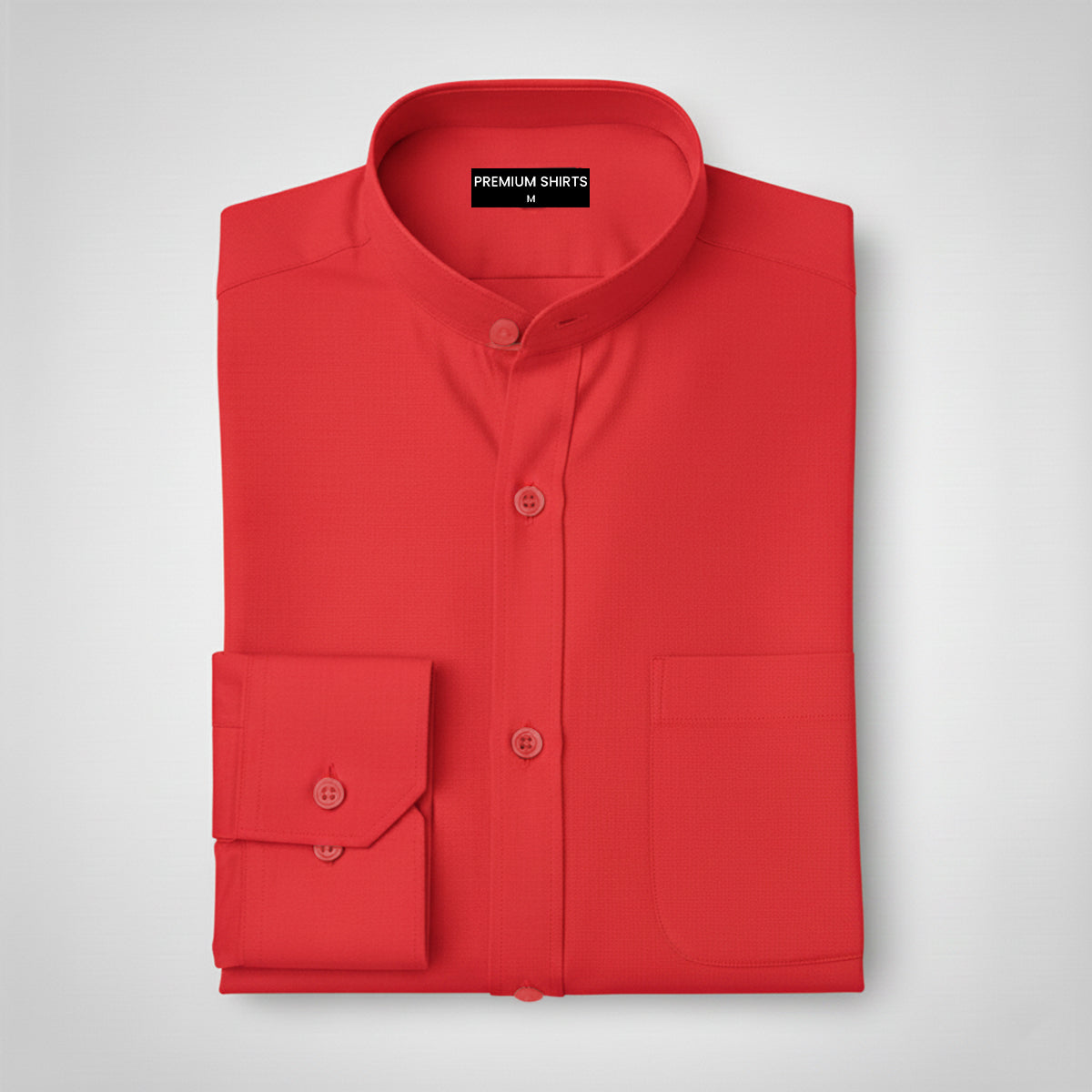 Folded red shirt with a label on a light gray background