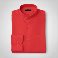 Folded red shirt with a label on a light gray background