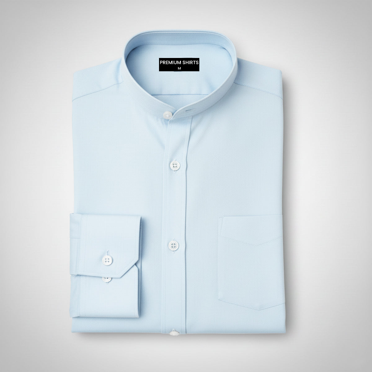 Folded light blue shirt on a gray background with 'Premium Shirts' label.