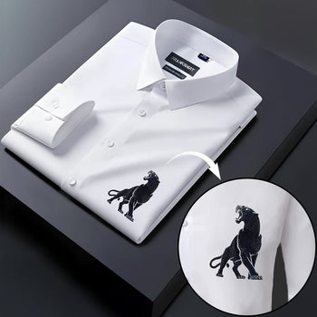 White dress shirt with black panther embroidery on a dark surface