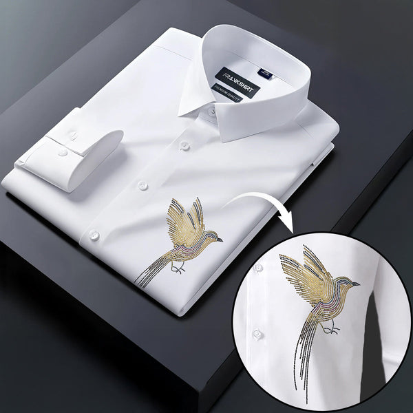 White dress shirt with gold bird embroidery on a dark surface