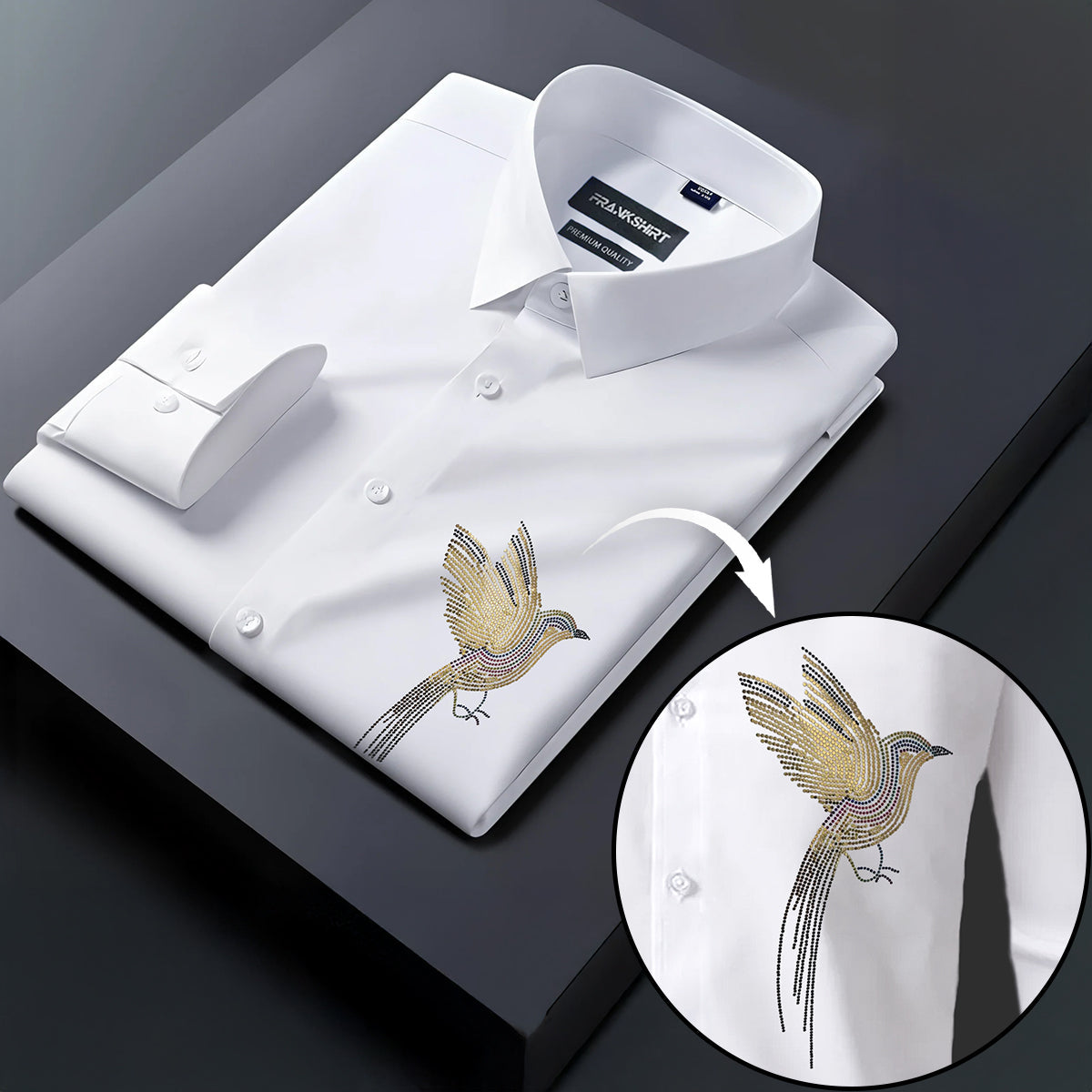 White dress shirt with gold bird embroidery on a dark surface