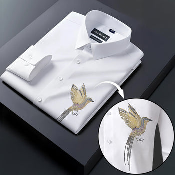 White dress shirt with gold bird embroidery on a dark surface